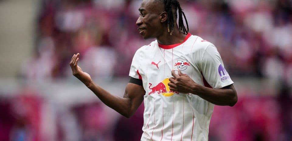 Player gesturing during match wearing RB Leipzig jersey