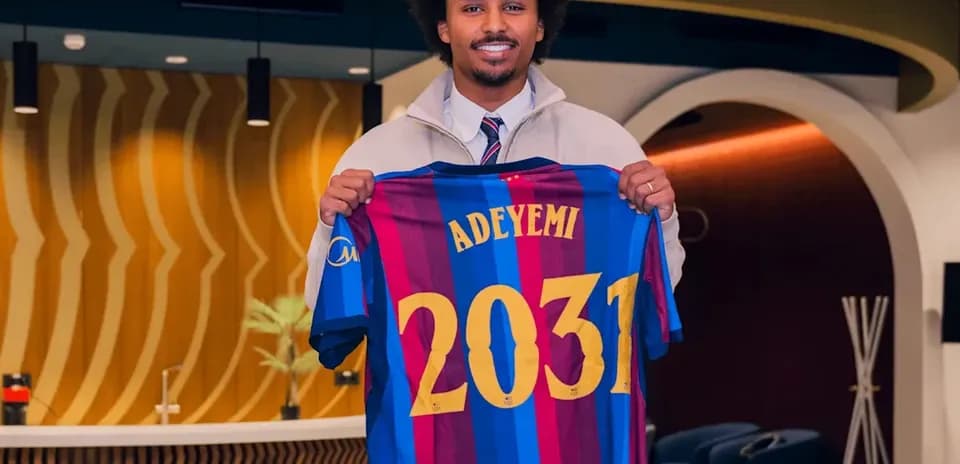 Player holding Barcelona jersey with name Adeyemi