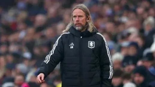 Manager standing on the sideline during match