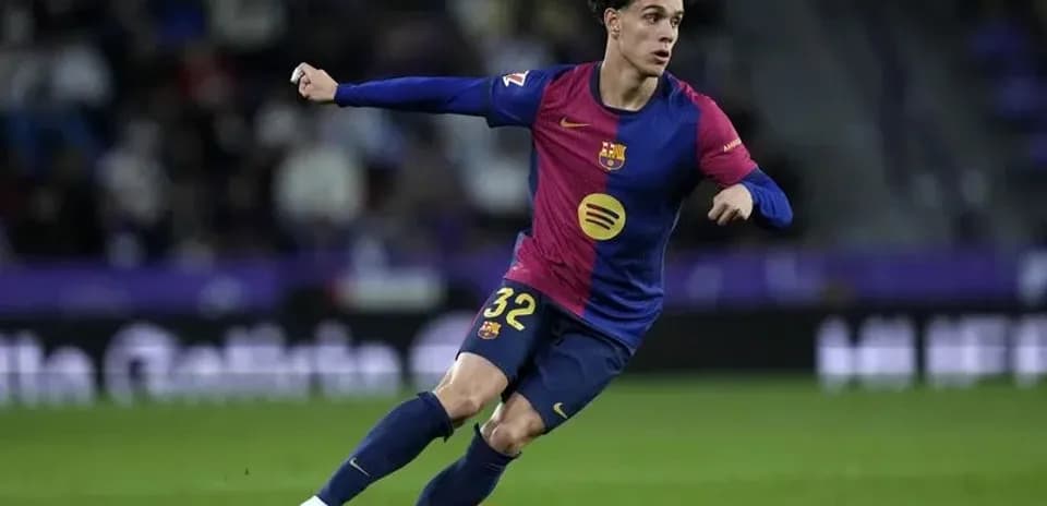 Player in Barcelona kit dribbling the ball on field