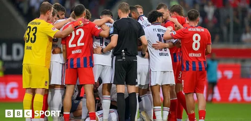 Players from both teams gathering around an injured player
