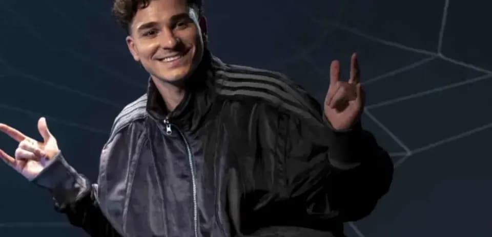 Person posing with hand gestures in dark setting