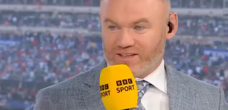 Presenter speaking into microphone at sports event
