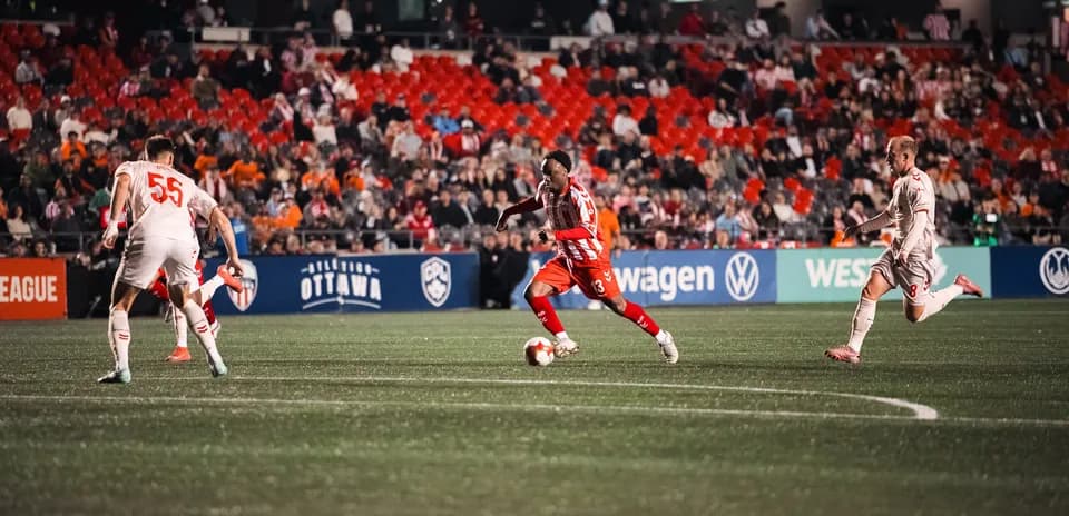 Player dribbling the ball during Atlético Ottawa match