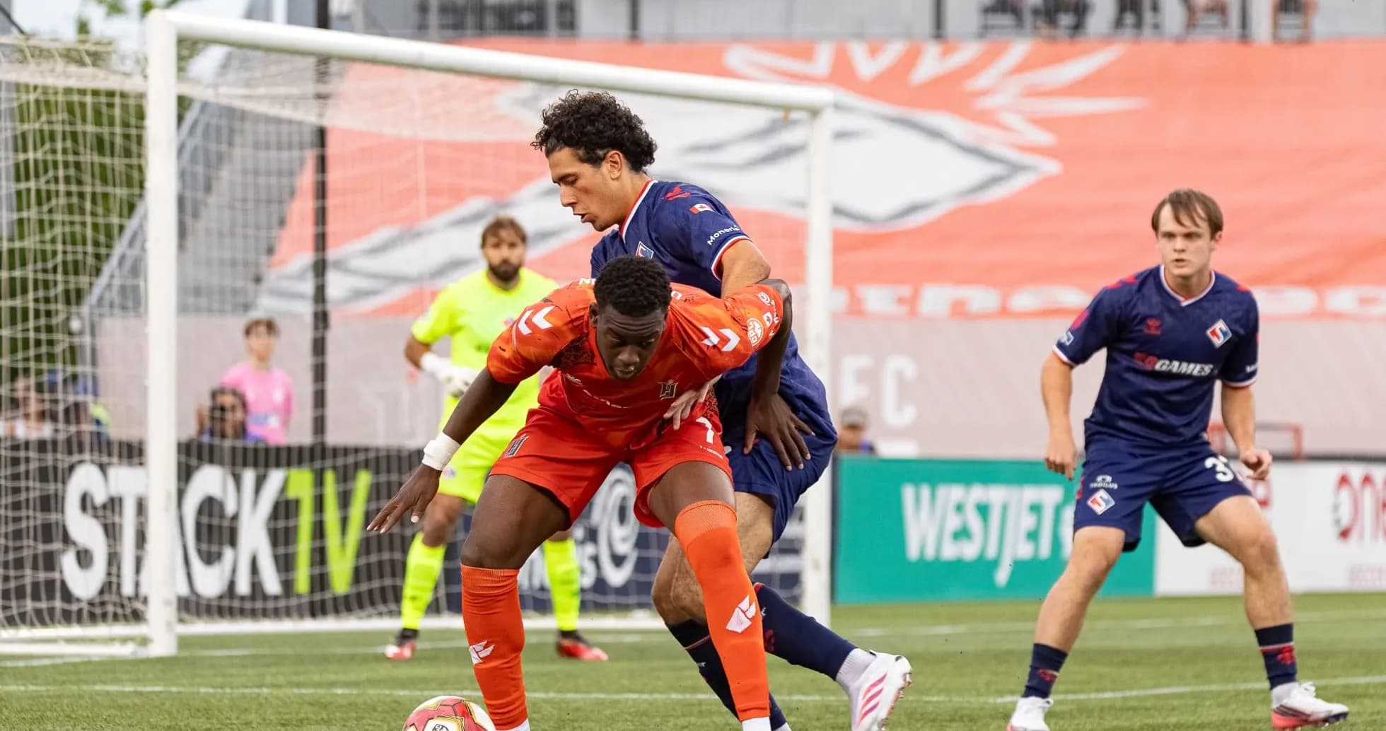 Players battling for the ball during match