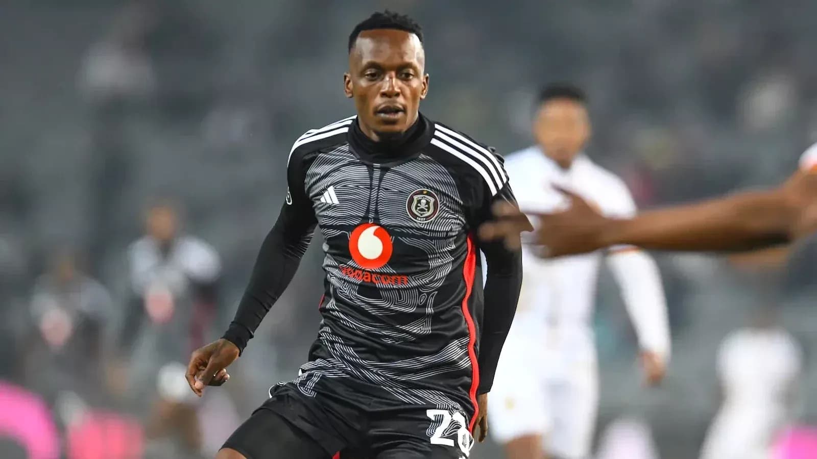 Player in action wearing Orlando Pirates kit