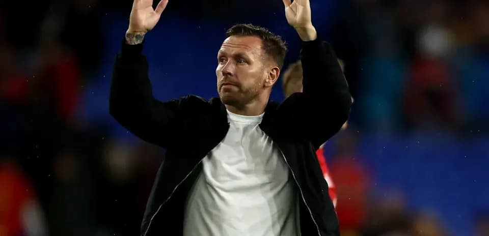 Man raising hands in acknowledgment after match