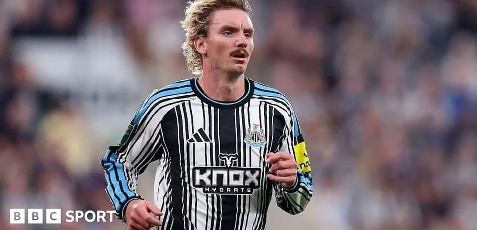 Player running in Newcastle United striped jersey