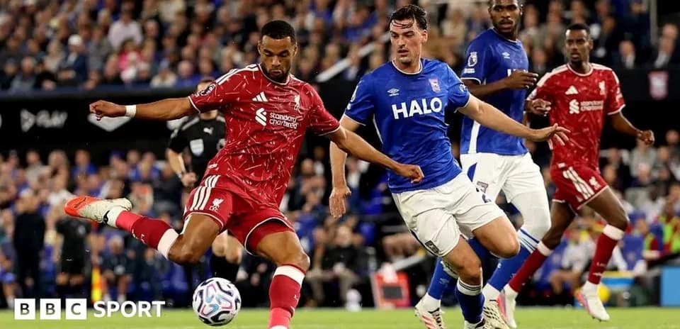 Liverpool player kicking the ball during match