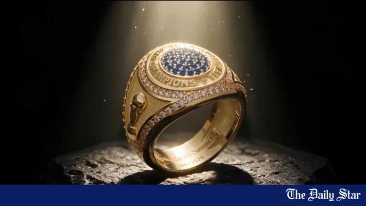 Championship ring displayed on a stone surface