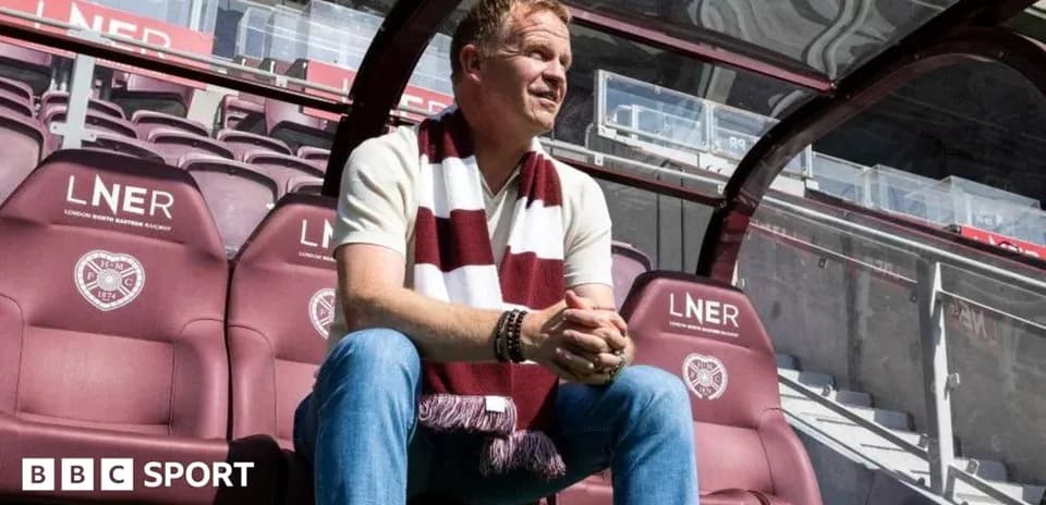 Manager sitting on bench at football stadium