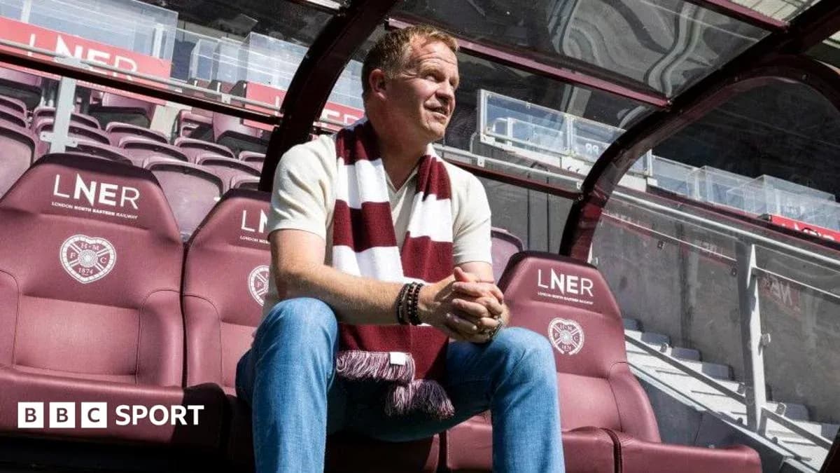 Manager sitting on bench at football stadium