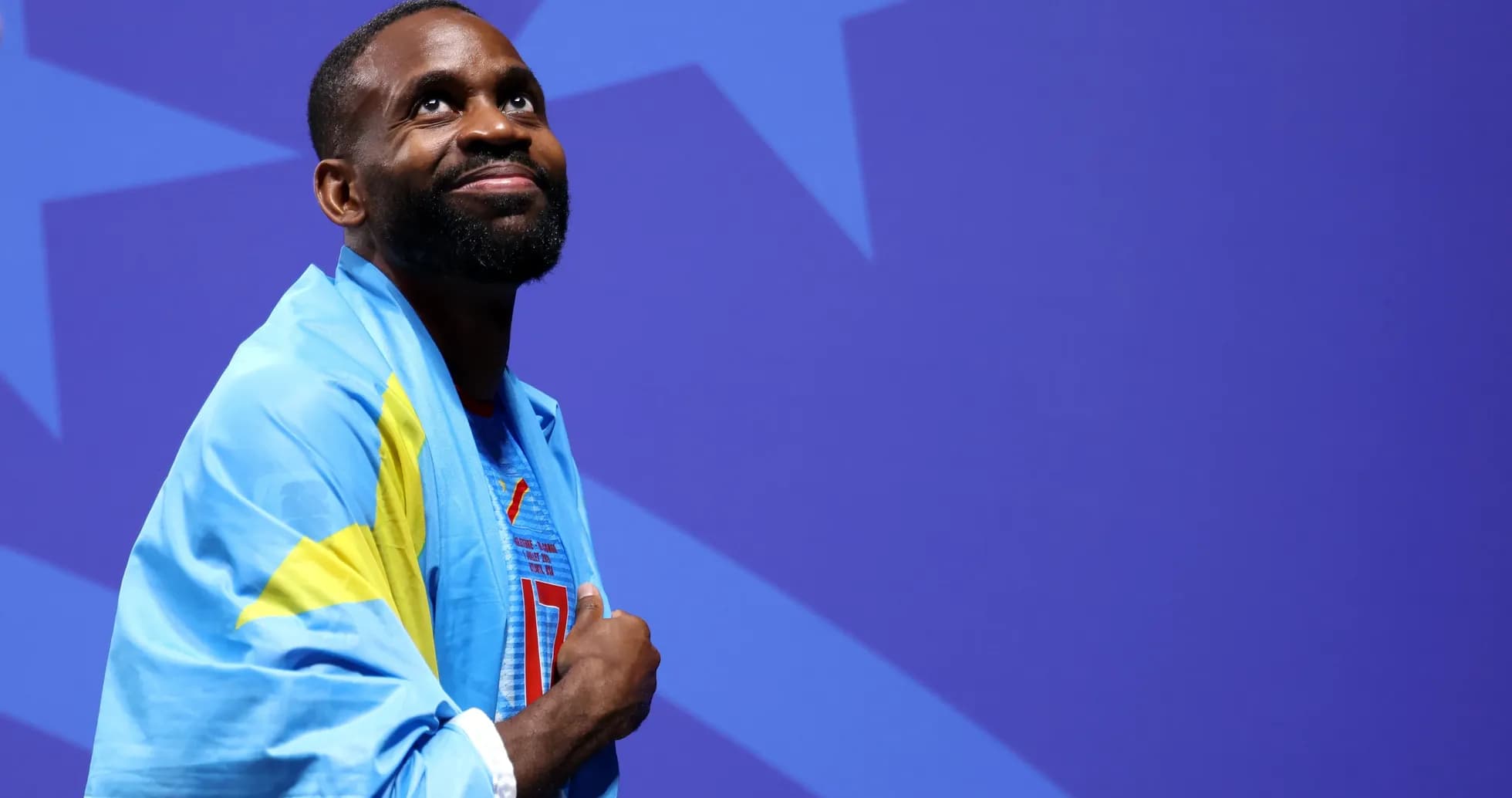 Athlete wearing a flag during a ceremony
