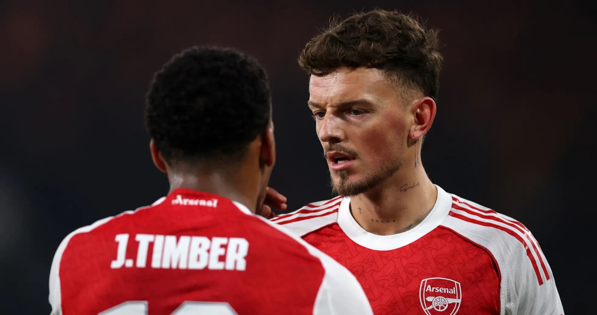 Two Arsenal players discussing during a match