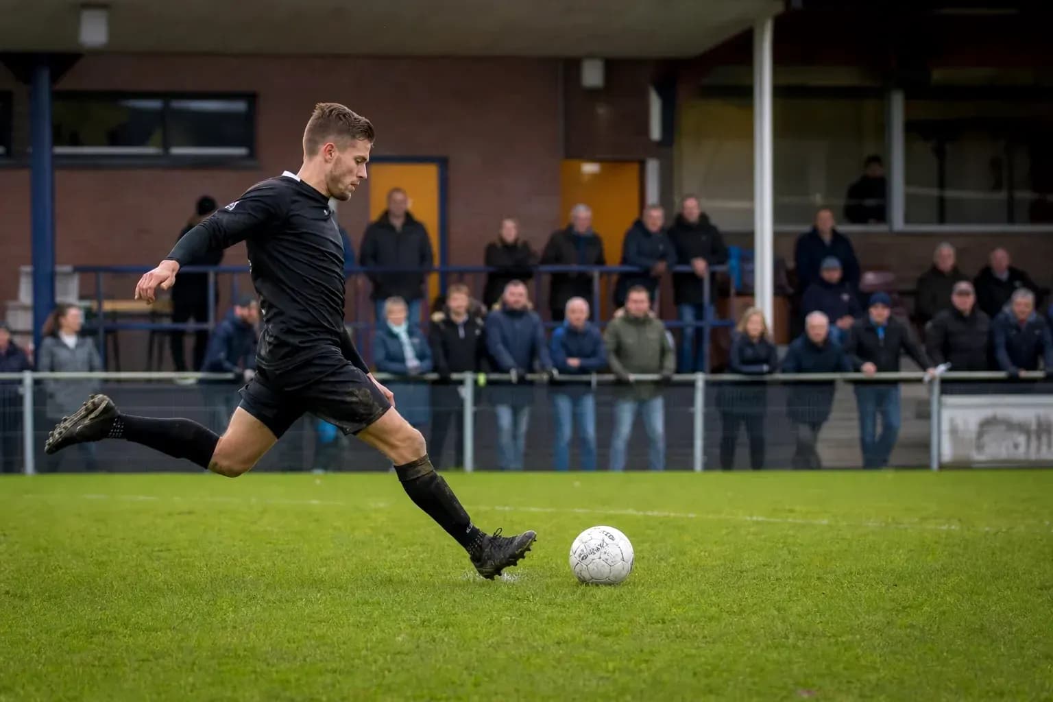 Player kicking a soccer ball during match