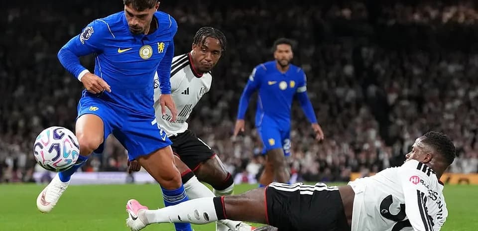 Fulham player tackling Chelsea forward in match