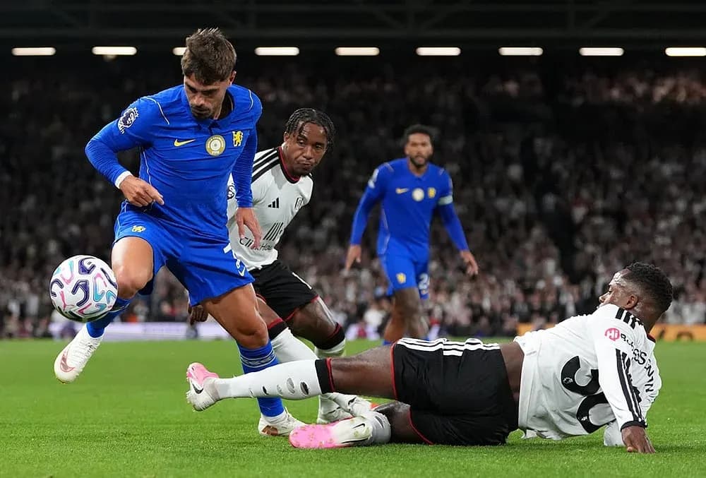 Fulham player tackling Chelsea forward in match