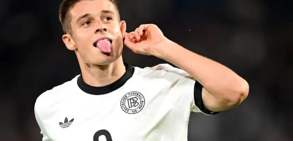 Player celebrating with tongue out after scoring