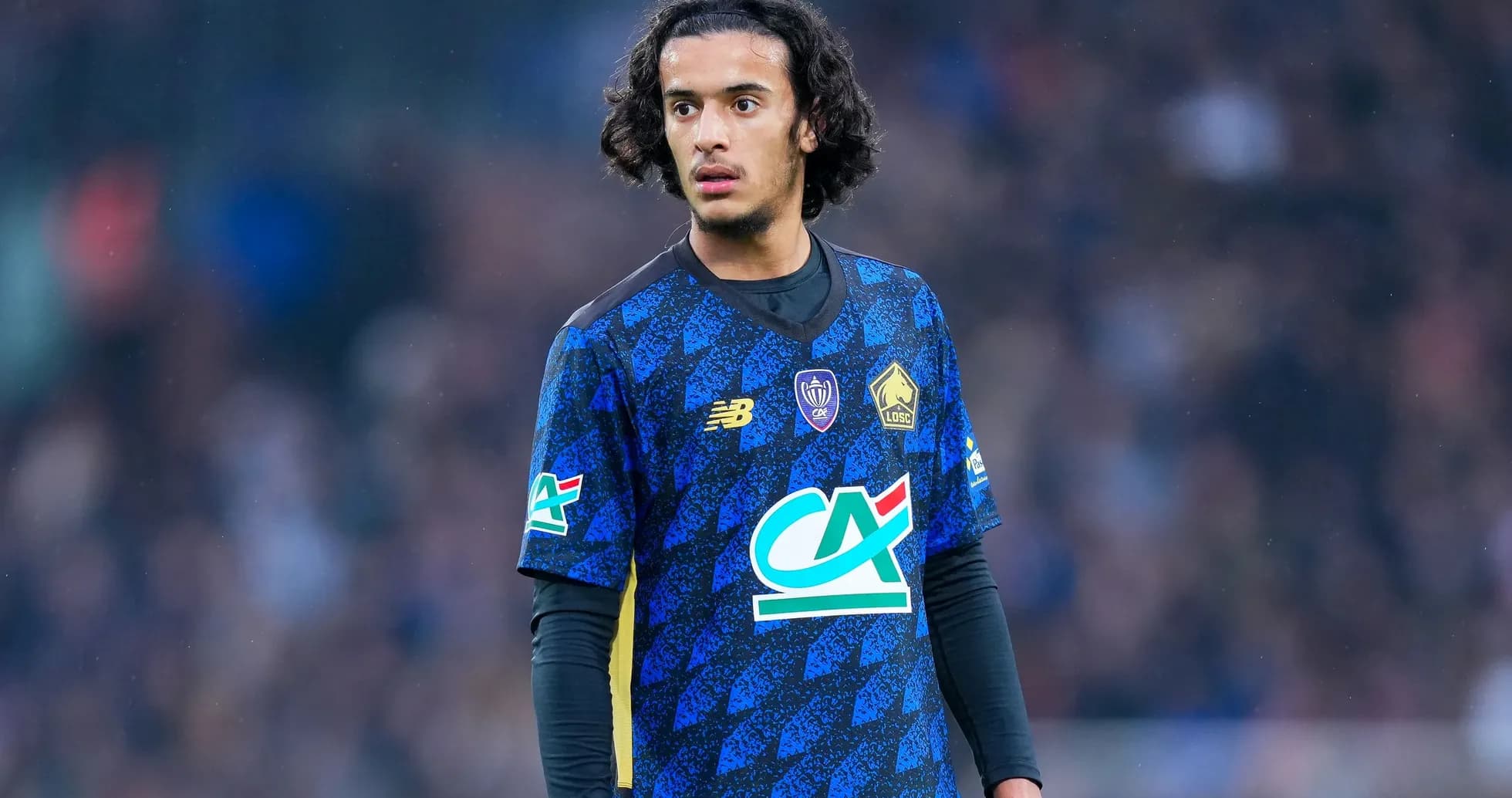 Player in blue Lille OSC jersey on the field
