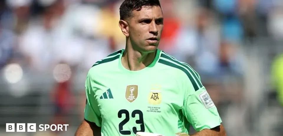 Goalkeeper in green kit during match warm-up