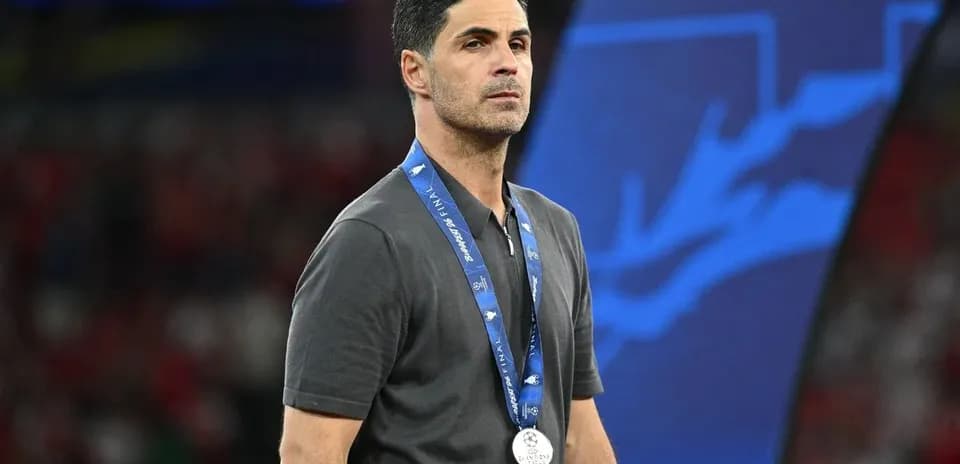 Coach wearing a silver medal at event