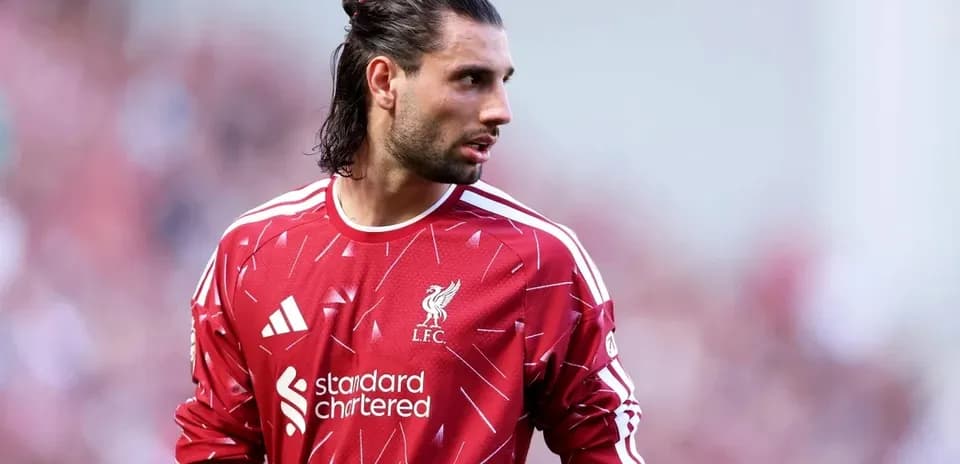 Goalkeeper in Liverpool FC jersey on the pitch