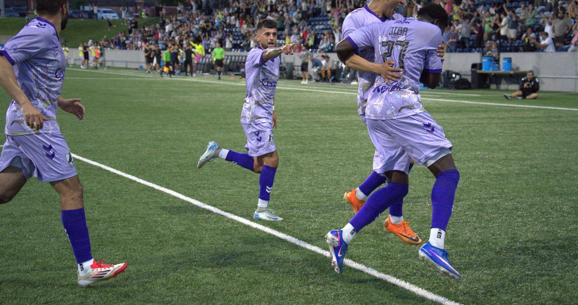 Players celebrating a goal during Union Omaha match