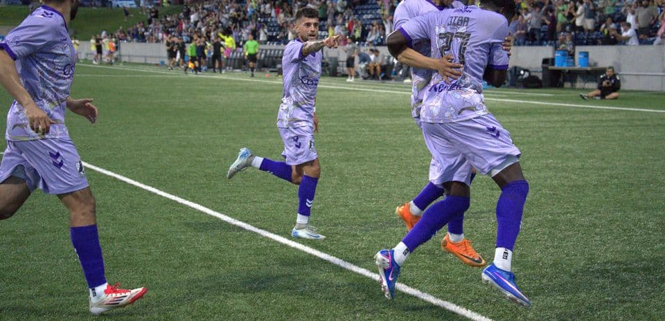 Players celebrating a goal during Union Omaha match
