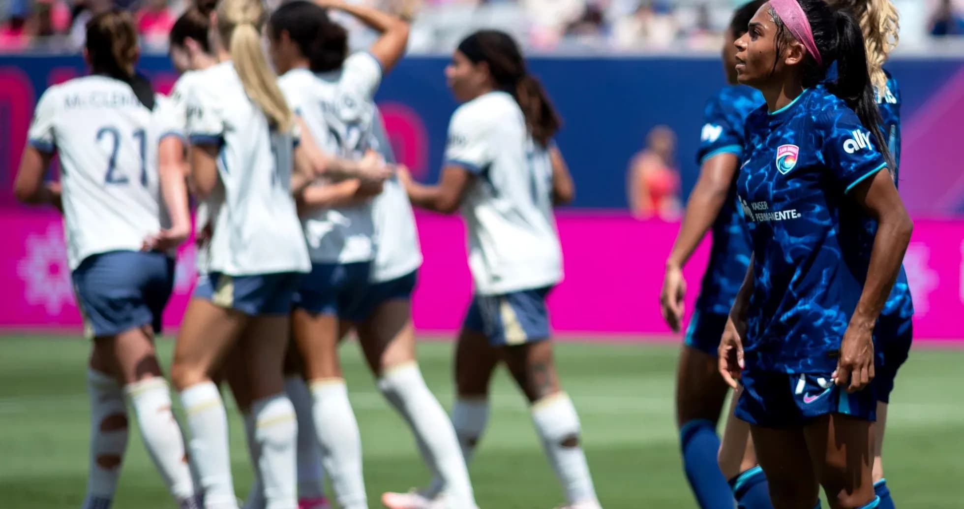Players celebrating a goal during NWSL match