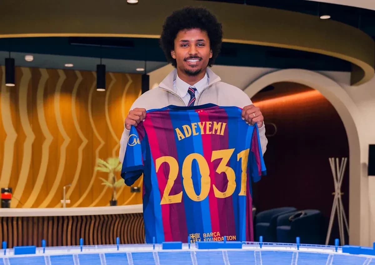 Player holding FC Barcelona jersey with name Adeyemi
