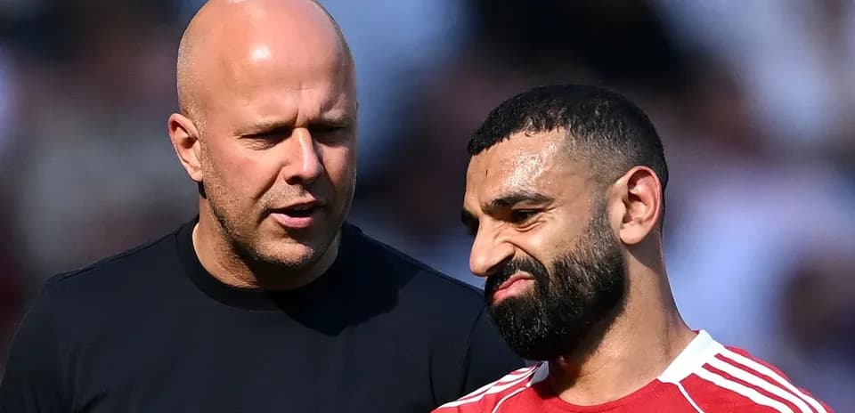 Two men discussing on the field after match