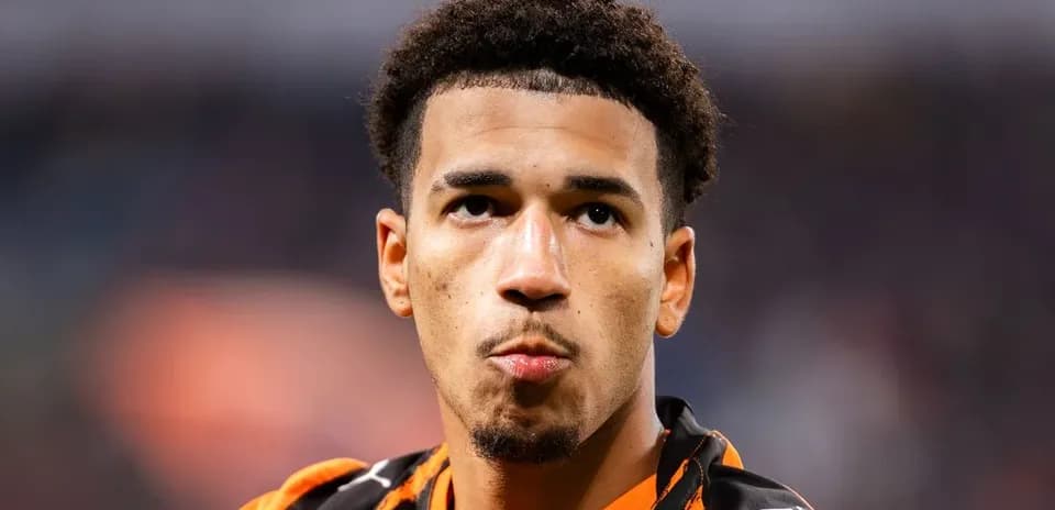 Player in orange jersey during match close-up