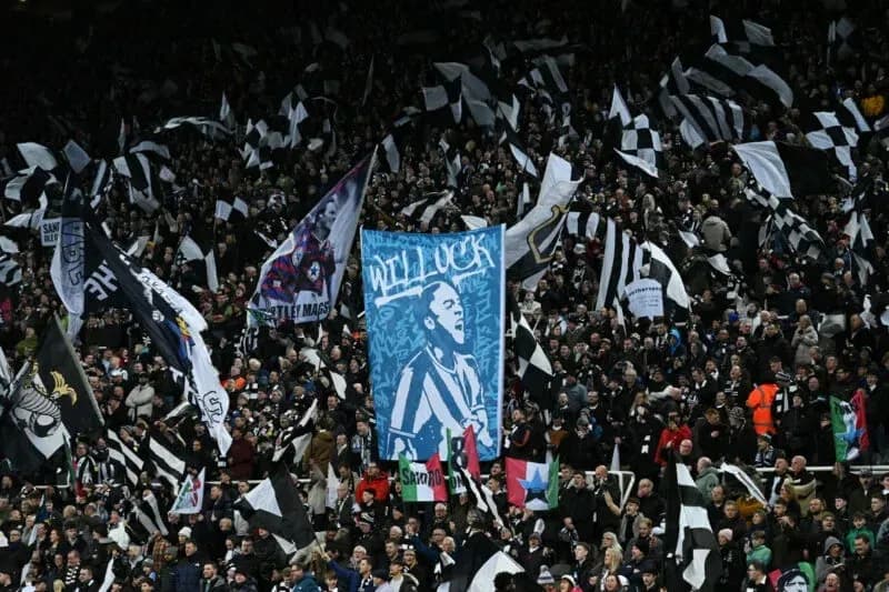 Newcastle United fans waving flags and banners