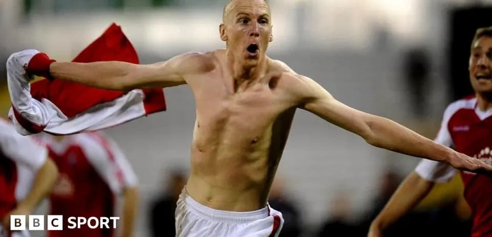 Player celebrating with shirt after scoring goal