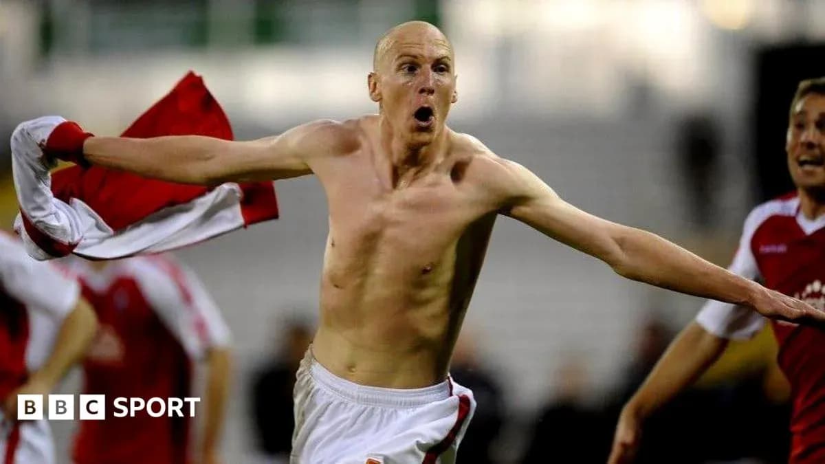 Player celebrating with shirt after scoring goal