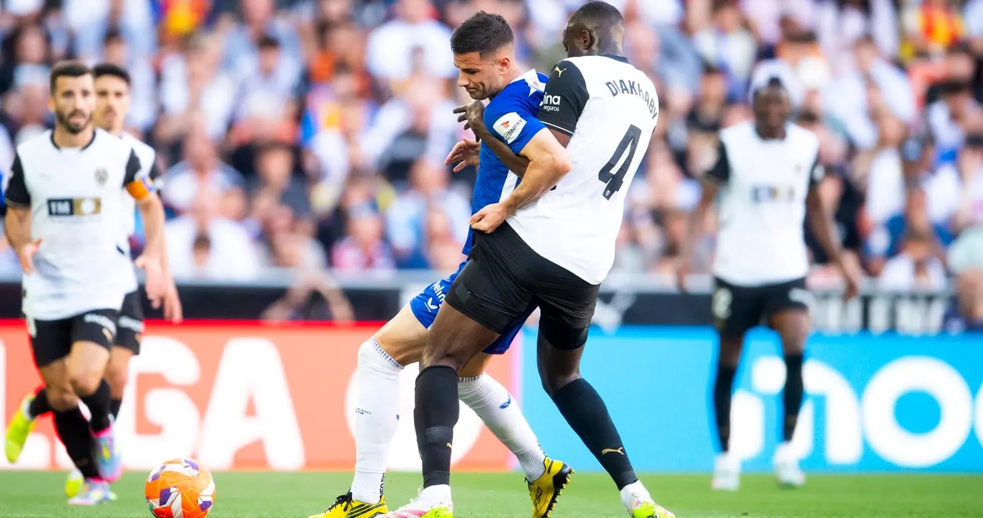 Athletic Club player challenging Valencia defender