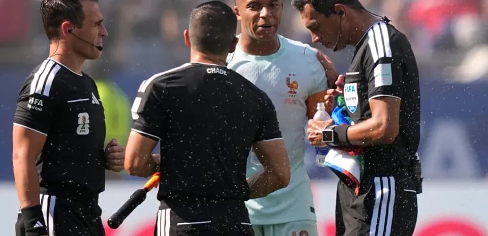 Referees discussing with player during match