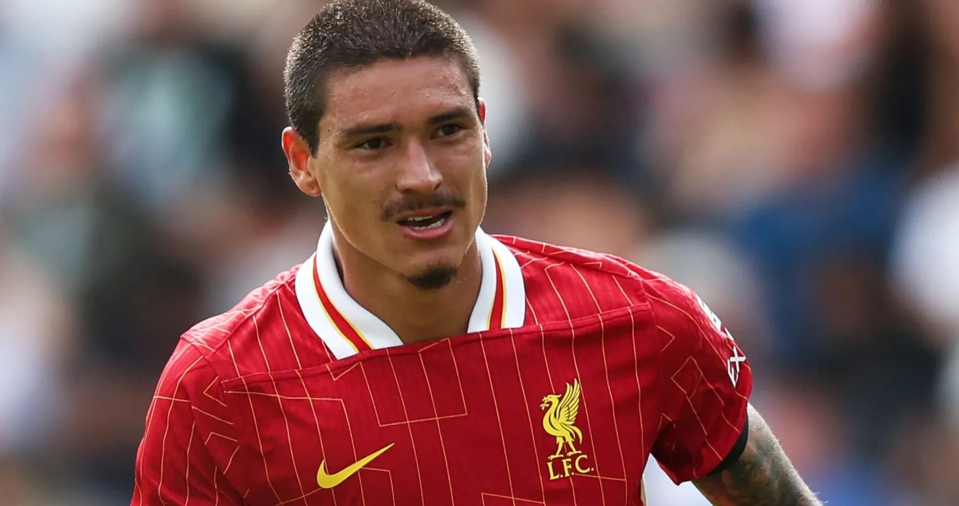 Player running in Liverpool jersey during match