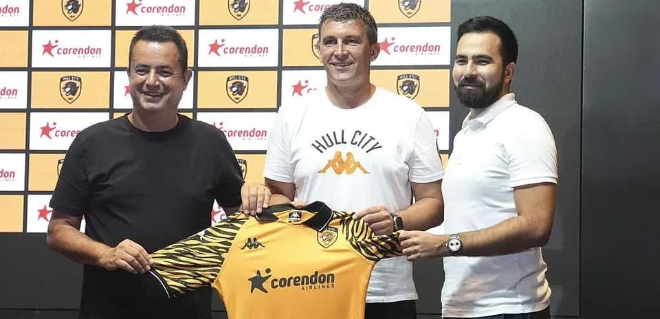 New manager holding Hull City jersey at announcement
