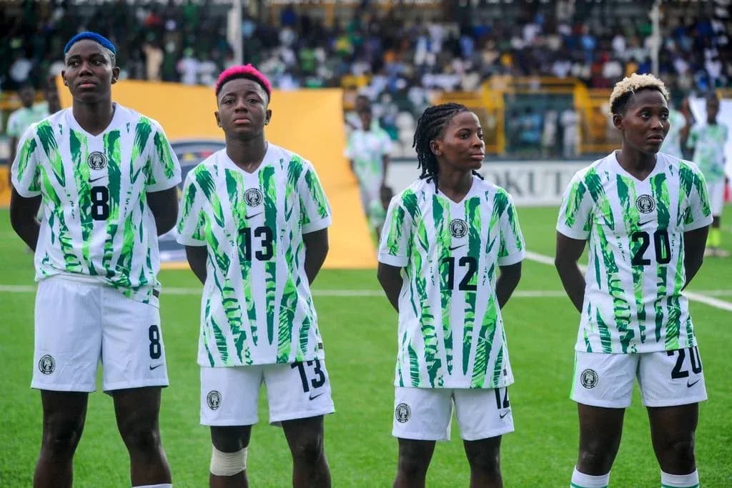 Four players in Nigeria jerseys standing together
