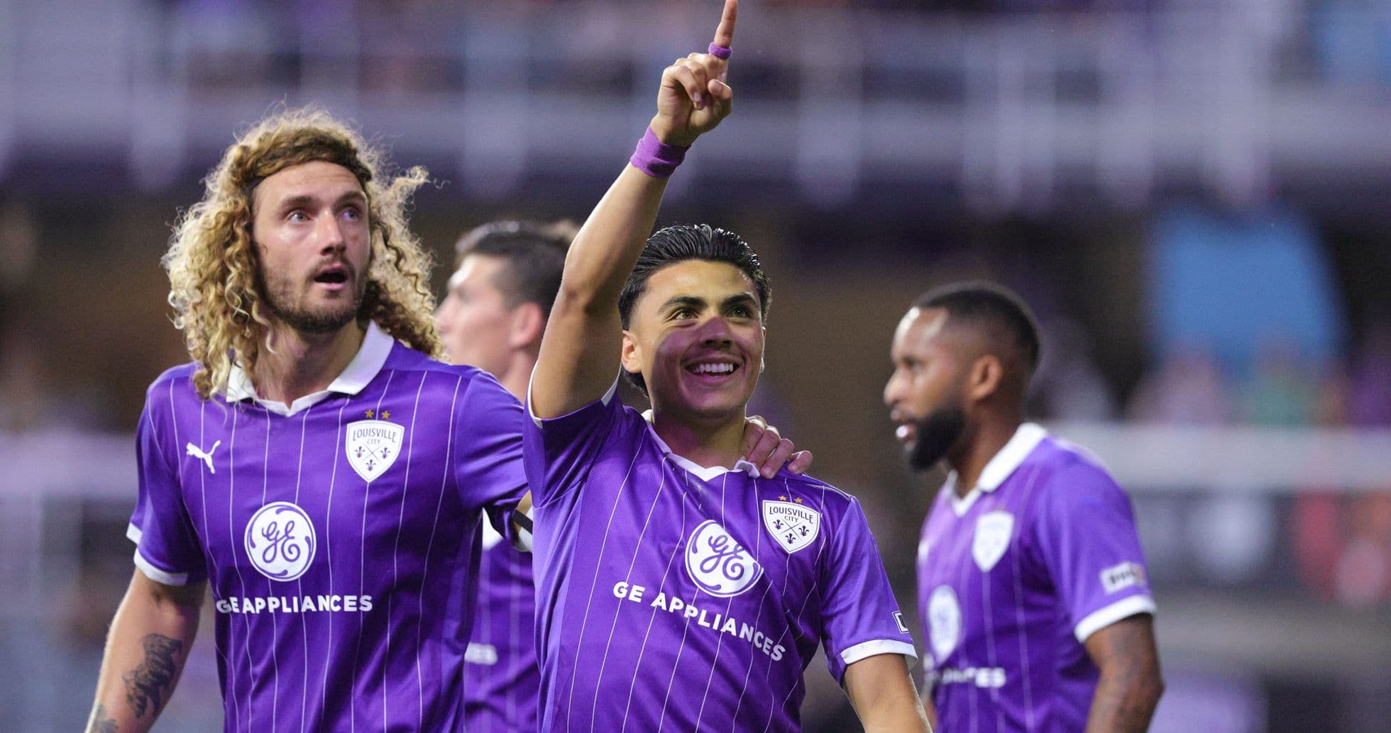 Louisville City players celebrating a goal