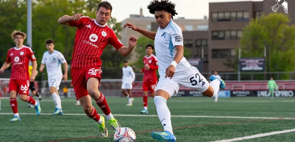Players competing for the ball during MLS Next Pro match