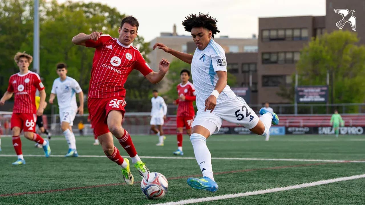 Players competing for the ball during MLS Next Pro match