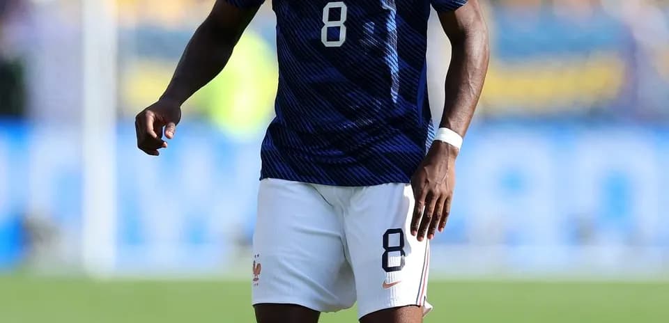 Player in France kit with ball on field