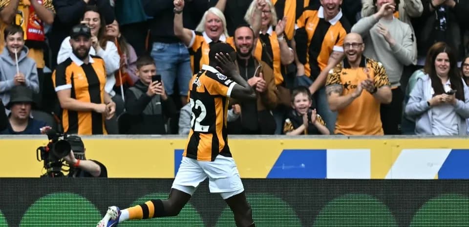 Player celebrating in front of cheering fans