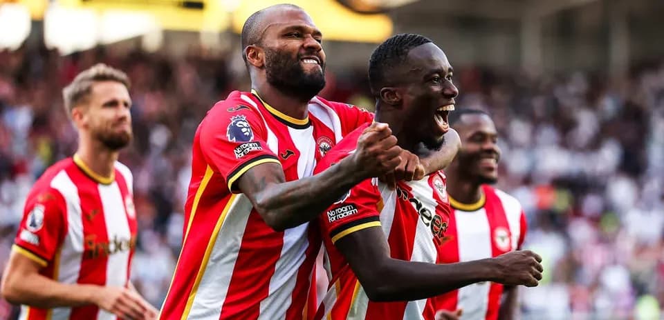 Brentford players celebrating a goal on the pitch