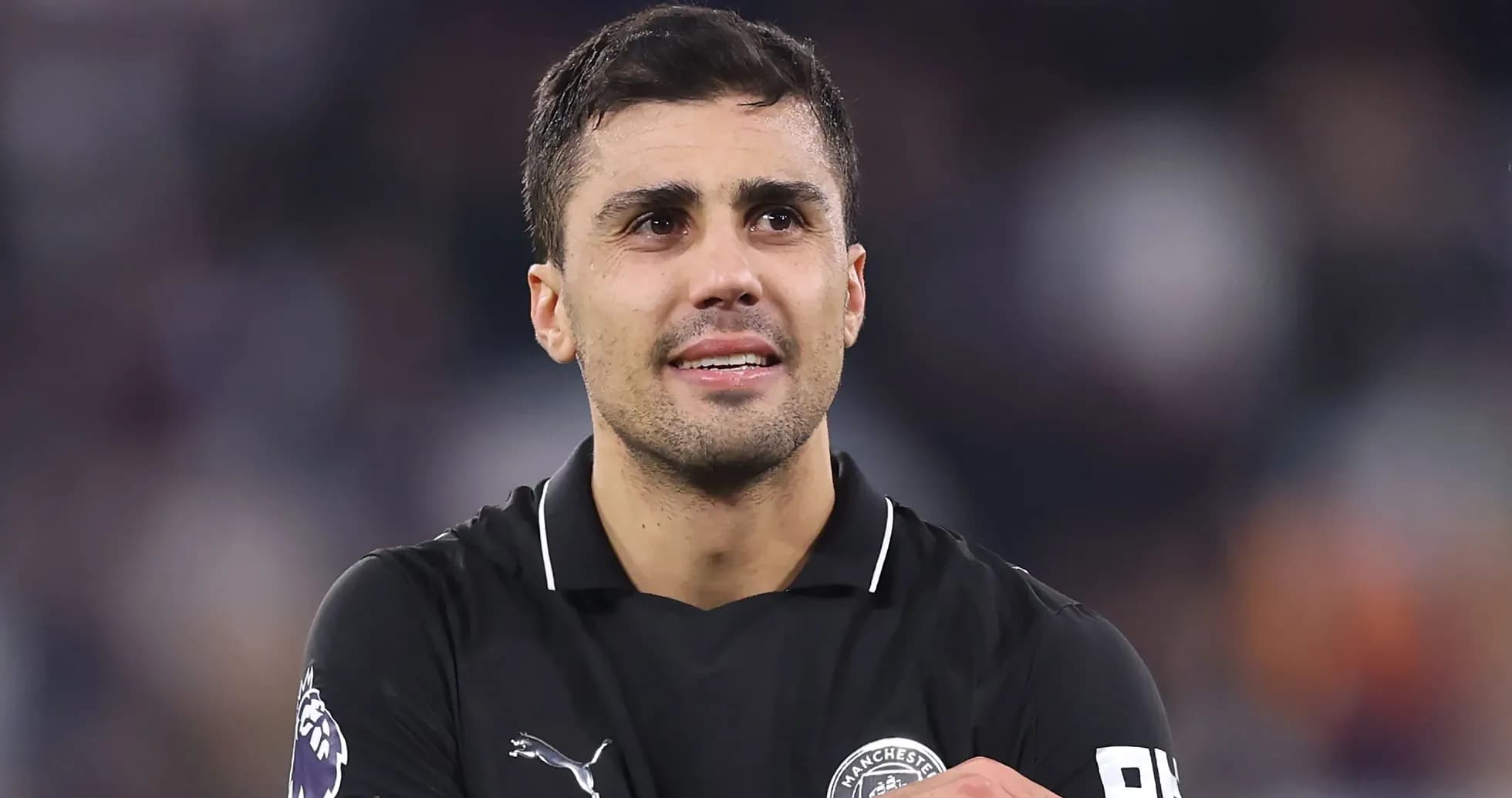 Player in black jersey celebrating after match