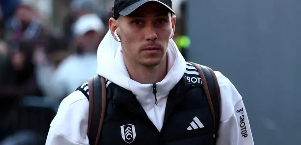 Player arriving at venue wearing team jacket