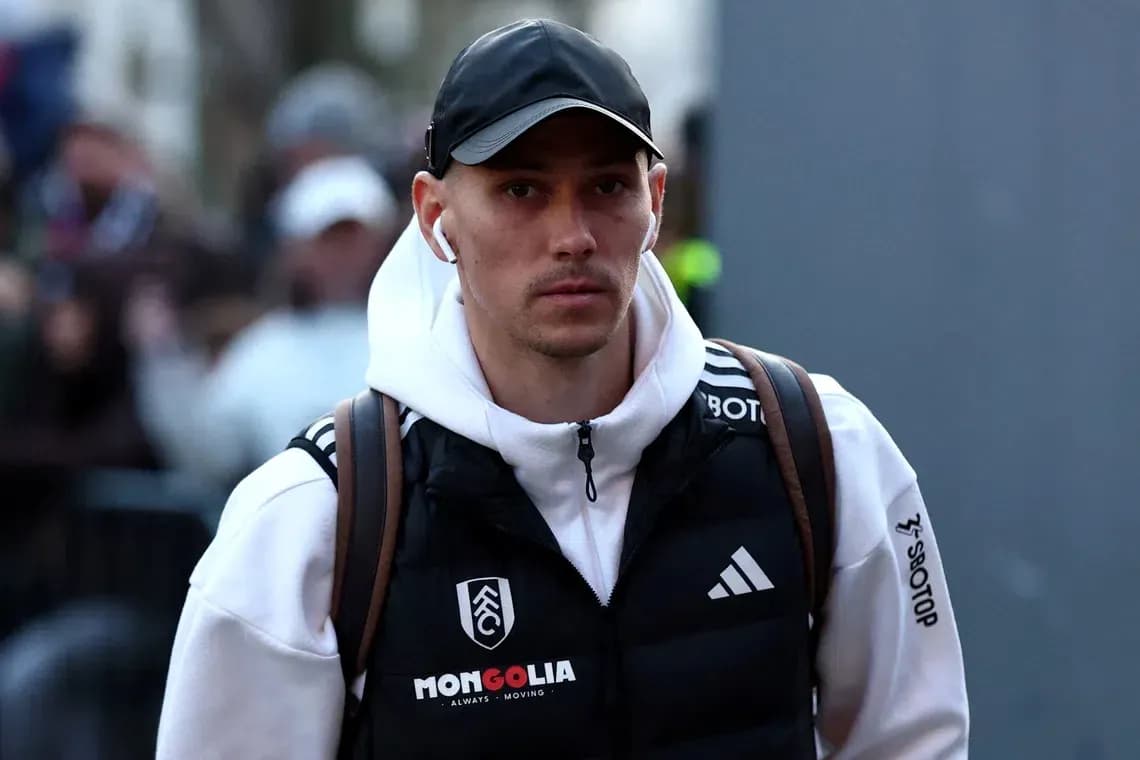 Player arriving at venue wearing team jacket