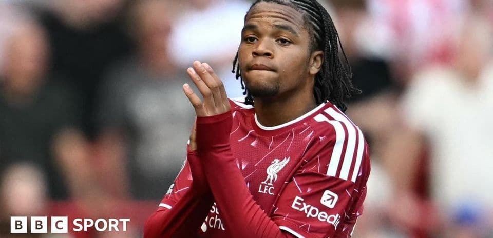 Player in Liverpool jersey applauding fans
